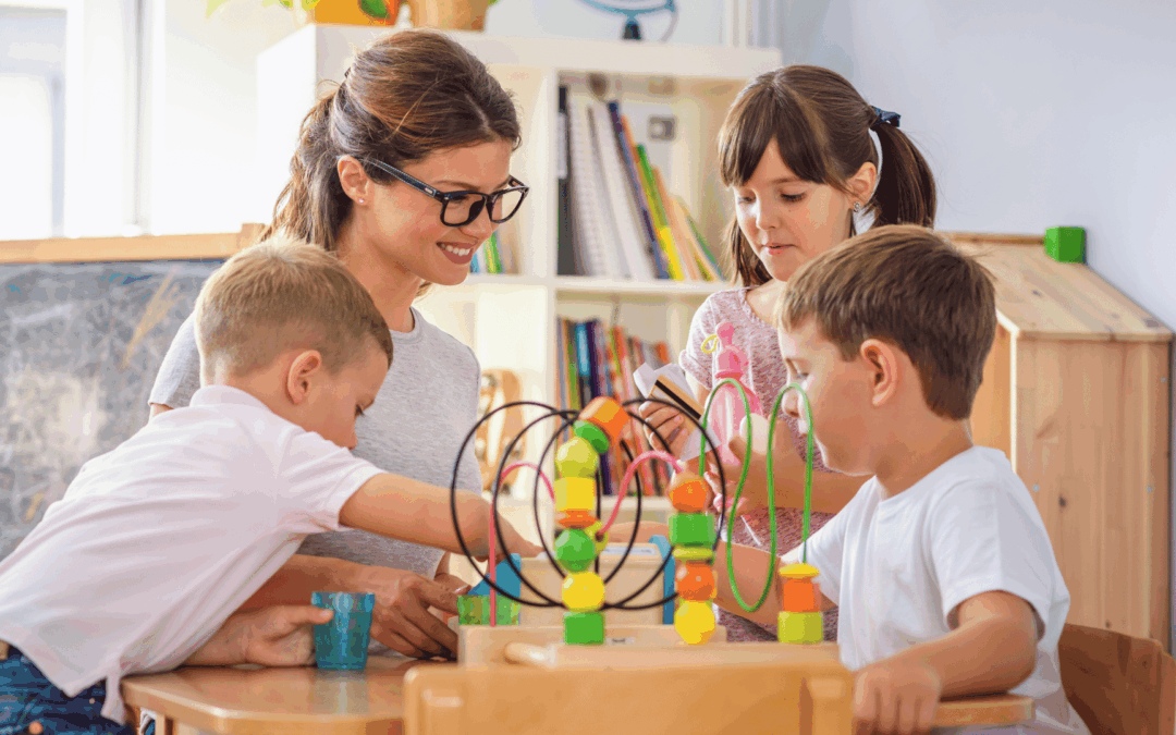 Teacher guiding young children through preschool activities with colorful wooden blocks at a classroom table