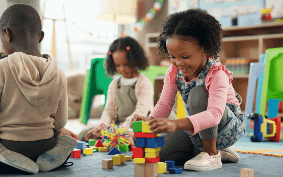 Play based learning in action as young children explore and build with colorful blocks in a bright classroom